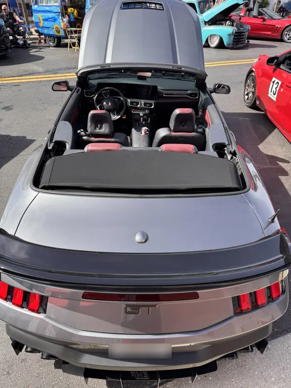 Overhead rear view showing black and red interior, spoiler, and EMP diffuser
