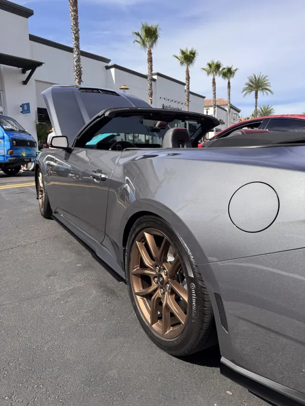Bronze factory wheel on Continental tire, rear quarter panel